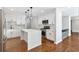Modern kitchen features stainless steel appliances, a center island and hardwood floors at 100 Little Ridge Rd, Berkeley Lake, GA 30096