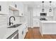Bright kitchen with white cabinets, quartz countertops, subway tile backsplash, and stainless steel appliances at 100 Little Ridge Rd, Berkeley Lake, GA 30096