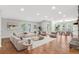 Open-concept living and dining area with hardwood floors, stone fireplace and natural light at 100 Little Ridge Rd, Berkeley Lake, GA 30096