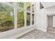 Bright living room with soaring ceilings, large windows and views of the surrounding greenery at 100 Little Ridge Rd, Berkeley Lake, GA 30096