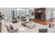 Spacious living room with hardwood floors, a stone fireplace and a dining area at 100 Little Ridge Rd, Berkeley Lake, GA 30096