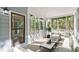 Screened porch with white furniture and a view into the backyard trees at 100 Little Ridge Rd, Berkeley Lake, GA 30096