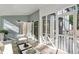 Comfortable screened porch with white furniture and a door into the main house at 100 Little Ridge Rd, Berkeley Lake, GA 30096