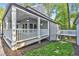 Side view of covered porch with elegant lighting and a connecting walkway at 100 Little Ridge Rd, Berkeley Lake, GA 30096