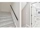 Carpeted staircase leads to a bathroom with marble floors, a double sink, and a shower at 100 Little Ridge Rd, Berkeley Lake, GA 30096