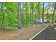 Landscape view of tree-filled backyard showing winding pathways and serene environment at 100 Little Ridge Rd, Berkeley Lake, GA 30096