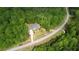 The aerial view shows a home situated among surrounding trees with a long driveway at 1080 Gaithers Rd, Mansfield, GA 30055