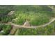 The aerial view shows this beautiful home surrounded by a lush forest of trees at 1080 Gaithers Rd, Mansfield, GA 30055