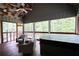 Inviting screened-in porch with hot tub, seating area, and serene wooded views at 1080 Gaithers Rd, Mansfield, GA 30055