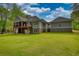 Expansive backyard featuring lush green lawn and multi-level screened porch at 1080 Gaithers Rd, Mansfield, GA 30055