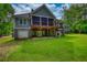 Expansive backyard featuring lush green lawn and multi-level screened porch at 1080 Gaithers Rd, Mansfield, GA 30055
