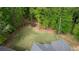 Aerial view of backyard with a trampoline for recreation surrounded by lush trees at 1080 Gaithers Rd, Mansfield, GA 30055