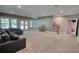 Open basement living space with carpet, walkout door, and staircase access at 1080 Gaithers Rd, Mansfield, GA 30055