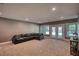 Large finished basement with carpet, comfortable couch and double door walkout access at 1080 Gaithers Rd, Mansfield, GA 30055
