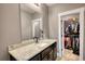 Bathroom vanity with granite countertop and decorative mirror at 1080 Gaithers Rd, Mansfield, GA 30055