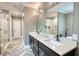 Modern bathroom features a double sink vanity, a glass-enclosed shower, and stylish tile flooring at 1080 Gaithers Rd, Mansfield, GA 30055