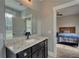 Bright bathroom vanity with granite counters and open doorway to the bedroom at 1080 Gaithers Rd, Mansfield, GA 30055