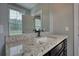 Bathroom vanity with granite countertop under a window at 1080 Gaithers Rd, Mansfield, GA 30055