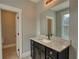 Bathroom vanity with dark cabinets, granite countertop, and doorway to water closet at 1080 Gaithers Rd, Mansfield, GA 30055