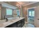 Bathroom with double vanity, granite countertop, and an open doorway to the bedroom at 1080 Gaithers Rd, Mansfield, GA 30055