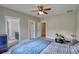 Spacious bedroom with drum set, a ceiling fan, and open doorways to the hallway and bath at 1080 Gaithers Rd, Mansfield, GA 30055