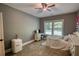 Cozy bedroom featuring a light color scheme and natural light from the window at 1080 Gaithers Rd, Mansfield, GA 30055