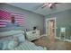 Cozy bedroom featuring plush bedding, a modern ceiling fan, and soft, neutral carpeting at 1080 Gaithers Rd, Mansfield, GA 30055