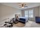 Cozy bedroom with ceiling fan, large windows, and drum set at 1080 Gaithers Rd, Mansfield, GA 30055