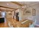 Spacious dining area adjacent to kitchen, featuring rustic wooden accents and modern light fixtures at 1080 Gaithers Rd, Mansfield, GA 30055