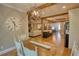 View from dining area to the kitchen and living room with open layout and wooden accents at 1080 Gaithers Rd, Mansfield, GA 30055