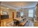 This dining room features a wooden table, wooden bench, and a chandelier at 1080 Gaithers Rd, Mansfield, GA 30055