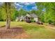 Beautiful house with well manicured lawn and abundant trees on the property at 1080 Gaithers Rd, Mansfield, GA 30055