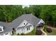 Beautiful exterior home elevation showcases manicured landscaping, and covered porch at 1080 Gaithers Rd, Mansfield, GA 30055