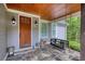 Cozy front porch with stone flooring, wood ceiling, and a relaxing swing at 1080 Gaithers Rd, Mansfield, GA 30055