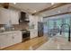 Modern kitchen offers white cabinets, stainless steel appliances and wood floors at 1080 Gaithers Rd, Mansfield, GA 30055