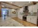 Modern kitchen with white cabinets, a black range hood, and wood floors at 1080 Gaithers Rd, Mansfield, GA 30055