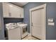 Bright laundry room with white cabinets and modern washer and dryer at 1080 Gaithers Rd, Mansfield, GA 30055