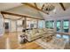 Spacious living area featuring exposed wood beams, access to patio, and an open floorplan at 1080 Gaithers Rd, Mansfield, GA 30055