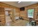 Living room with wood walls and window bringing natural light to the interior at 1080 Gaithers Rd, Mansfield, GA 30055