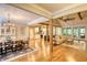 Open concept living room boasts hardwood floors, comfortable seating, and a view into the kitchen at 1080 Gaithers Rd, Mansfield, GA 30055