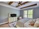 Comfortable bedroom featuring tray ceilings, wooden beams, and a window view of nature at 1080 Gaithers Rd, Mansfield, GA 30055