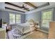 Tranquil bedroom with tray ceilings, natural light, and a decorative rug at 1080 Gaithers Rd, Mansfield, GA 30055