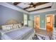 Inviting bedroom with tray ceilings, elegant furnishings, and access to a luxurious ensuite bathroom at 1080 Gaithers Rd, Mansfield, GA 30055