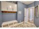 Well-organized mudroom with bench seating and storage cabinets at 1080 Gaithers Rd, Mansfield, GA 30055