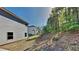 View of the backyard featuring a gentle slope with lush trees and greenery, providing a private outdoor space at 1280 Sw Vonda Ln, Mableton, GA 30126