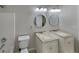 Bright bathroom featuring double vanity sinks and round mirrors, offering a modern and functional space at 1280 Sw Vonda Ln, Mableton, GA 30126