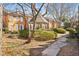 Scenic view of a neighborhood gazebo and lush landscaping surrounded by charming residential townhomes at 3476 Silver Maple Dr, Duluth, GA 30096