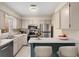 Clean kitchen with white cabinets, stainless steel appliances, and a breakfast bar at 3476 Silver Maple Dr, Duluth, GA 30096