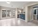 Open concept dining with modern kitchen, white cabinets and stainless appliances at 3476 Silver Maple Dr, Duluth, GA 30096