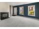 Bright living room featuring neutral carpet, a fireplace, and large windows with views of the outdoors at 3476 Silver Maple Dr, Duluth, GA 30096
